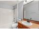 Bathroom showcasing tub-shower combo, modern vanity, and vanity mirror at 408 Magpie Ct, Kissimmee, FL 34759