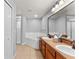 Bright bathroom with a soaking tub, double sinks, and a large mirror at 408 Magpie Ct, Kissimmee, FL 34759