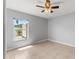 Bedroom with tiled floors, a ceiling fan, and a bright window showcasing a backyard view at 408 Magpie Ct, Kissimmee, FL 34759