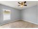 Neutral bedroom with tiled floors, ceiling fan, and a window at 408 Magpie Ct, Kissimmee, FL 34759