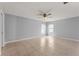 Clean bedroom featuring tile flooring, neutral paint, two windows and a ceiling fan with lots of natural light at 408 Magpie Ct, Kissimmee, FL 34759