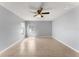 Large bedroom with a ceiling fan and lots of natural light from the two windows overlooking the front yard at 408 Magpie Ct, Kissimmee, FL 34759
