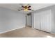 Bedroom with tile floors, a ceiling fan, and a double door closet at 408 Magpie Ct, Kissimmee, FL 34759