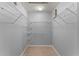 Walk-in closet with shelving, neutral tile flooring, and gray walls at 408 Magpie Ct, Kissimmee, FL 34759