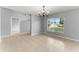 Light-filled dining room with tile floors, modern chandelier, and a view to the front at 408 Magpie Ct, Kissimmee, FL 34759