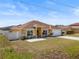 Charming single-story home with a well-maintained lawn, white fence, and two-car garage at 408 Magpie Ct, Kissimmee, FL 34759