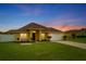 Yellow home with a well-maintained lawn, two-car garage, and classic curb appeal in a suburban setting at 408 Magpie Ct, Kissimmee, FL 34759