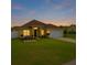 Beautiful yellow home with a two-car garage, and well-maintained lawn in a quiet neighborhood at 408 Magpie Ct, Kissimmee, FL 34759