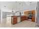 Inviting kitchen area with stainless steel appliances, wooden cabinets, and an open layout at 408 Magpie Ct, Kissimmee, FL 34759