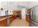 Modern kitchen featuring stainless steel appliances, wood cabinets, and tile flooring at 408 Magpie Ct, Kissimmee, FL 34759