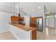 Open kitchen with a breakfast bar, stainless steel appliances, and vaulted ceilings at 408 Magpie Ct, Kissimmee, FL 34759