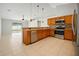 Modern kitchen with stainless steel appliances, tile flooring, and pendant lighting at 408 Magpie Ct, Kissimmee, FL 34759