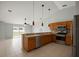 Modern kitchen with stainless steel appliances, tile flooring, and pendant lighting at 408 Magpie Ct, Kissimmee, FL 34759