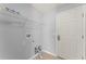 A bright laundry room with shelving, gray walls and connections for a washer and dryer at 408 Magpie Ct, Kissimmee, FL 34759
