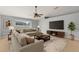 Comfortable living room featuring a large sectional sofa, modern entertainment center, and neutral color palette at 408 Magpie Ct, Kissimmee, FL 34759
