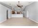 Open-concept living room with tile flooring, neutral paint, and a view into the eat-in kitchen at 408 Magpie Ct, Kissimmee, FL 34759