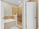 Bright bathroom featuring shower and tub with tile surround, and neutral walls at 458 Ellis Square Ct, Sanford, FL 32771