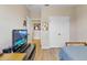 Bedroom with a twin bed, office desk, television, and natural light from the window at 458 Ellis Square Ct, Sanford, FL 32771