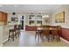 Bright dining area with stylish chandelier, tile flooring, and ample seating at 458 Ellis Square Ct, Sanford, FL 32771
