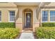 Inviting front entrance with decorative door, manicured shrubs and warm earth tone paint at 458 Ellis Square Ct, Sanford, FL 32771