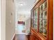 A cozy hallway showcases a wooden china cabinet and leads to a dining area with bright light at 458 Ellis Square Ct, Sanford, FL 32771