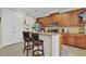 Traditional kitchen features wood cabinets, tile floor, granite countertop, and stainless steel appliances at 458 Ellis Square Ct, Sanford, FL 32771