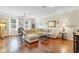 Bright living room with hardwood floors, neutral paint, and a comfortable sectional sofa at 458 Ellis Square Ct, Sanford, FL 32771
