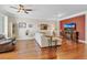 Open-concept living room with hardwood floors, neutral paint, and a comfortable sectional sofa at 458 Ellis Square Ct, Sanford, FL 32771