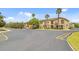 Charming townhouse community with well-maintained exteriors, palm trees, and convenient parking spaces at 458 Ellis Square Ct, Sanford, FL 32771