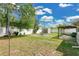 Large fenced backyard with a fire pit, shed, covered patio, and plenty of green space at 4646 Old Road 37, Lakeland, FL 33813