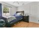 This bedroom features a large window, a ceiling fan, and luxury vinyl flooring at 4646 Old Road 37, Lakeland, FL 33813