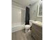 Well-lit bathroom featuring a shower-tub combo, modern vanity, and neutral color palette at 4706 Sutton Ter # 111A2, Orlando, FL 32811