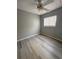 Cozy bedroom with a ceiling fan, window with blinds, and wood-look flooring at 4706 Sutton Ter # 111A2, Orlando, FL 32811