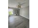 Cozy bedroom with mirrored closet doors, modern flooring, and natural light at 4706 Sutton Ter # 111A2, Orlando, FL 32811