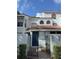 Charming townhouse exterior with black gated entrance, terracotta tile roof, and well-maintained landscaping at 4706 Sutton Ter # 111A2, Orlando, FL 32811