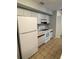 Functional kitchen with white appliances, tiled floor, and ample cabinet space at 4706 Sutton Ter # 111A2, Orlando, FL 32811