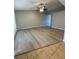 Spacious, bright living area with ceiling fan and sleek, grey flooring at 4706 Sutton Ter # 111A2, Orlando, FL 32811