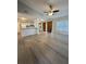 Open-concept living room featuring modern flooring and view of kitchen and laundry area at 4706 Sutton Ter # 111A2, Orlando, FL 32811