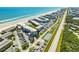 Scenic aerial shot of the condo complex, beach, and surrounding landscape at 4821 Saxon Dr # 201B, New Smyrna Beach, FL 32169