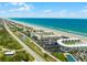 Expansive aerial view of beautiful coastline, condos, and pristine beach with shimmering turquoise ocean water at 4821 Saxon Dr # 201B, New Smyrna Beach, FL 32169