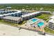 Stunning aerial view of the beachfront condo complex with pools and ocean access at 4821 Saxon Dr # 201B, New Smyrna Beach, FL 32169