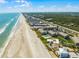 Stunning aerial view showcasing beachfront condos, beach access, and a tranquil ocean setting at 4821 Saxon Dr # 201B, New Smyrna Beach, FL 32169