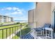 Relax on the balcony with seating and enjoy beautiful views of the ocean and the green lawn at 4821 Saxon Dr # 201B, New Smyrna Beach, FL 32169
