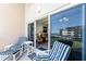 Relaxing balcony seating area with comfortable chairs and a table, offering a serene view of the surroundings at 4821 Saxon Dr # 201B, New Smyrna Beach, FL 32169