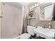 Functional bathroom with a walk-in shower, toilet, and vanity with bright lighting and neutral tones at 4821 Saxon Dr # 201B, New Smyrna Beach, FL 32169