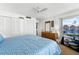 Spacious bedroom with ample closet space, dresser, TV, and large window providing natural light at 4821 Saxon Dr # 201B, New Smyrna Beach, FL 32169