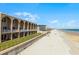 Beachfront condo complex featuring a direct beach access, multiple floors, and private balconies at 4821 Saxon Dr # 201B, New Smyrna Beach, FL 32169
