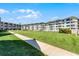 A well-maintained building and lawn offer a pleasant exterior view of the condos near the beach at 4821 Saxon Dr # 201B, New Smyrna Beach, FL 32169