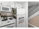 The white kitchen features modern appliances and cabinets for efficient food preparation and storage at 4821 Saxon Dr # 201B, New Smyrna Beach, FL 32169