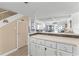 Kitchen with white cabinets and open access to the dining and living areas with beautiful view at 4821 Saxon Dr # 201B, New Smyrna Beach, FL 32169